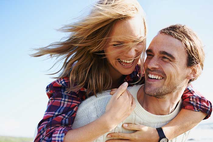 a couple happy and smiling outdoors