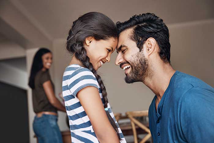 father and daughter playing in living room